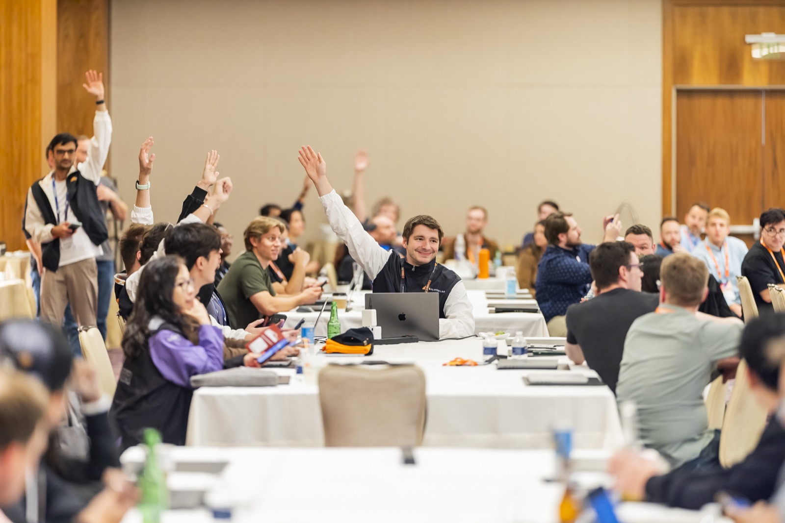 Attendees raising their hands during a technical breakout at Cloudflare Connect 2025